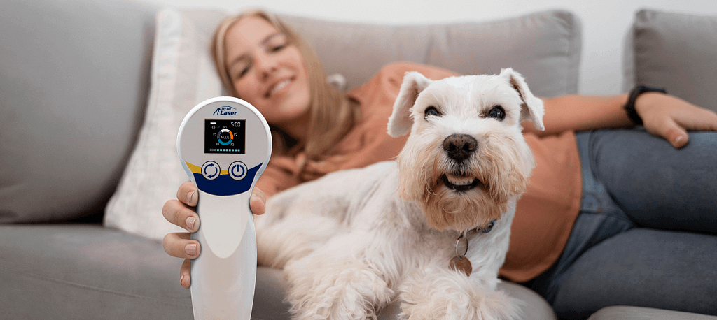 a woman lying on a couch with a dog